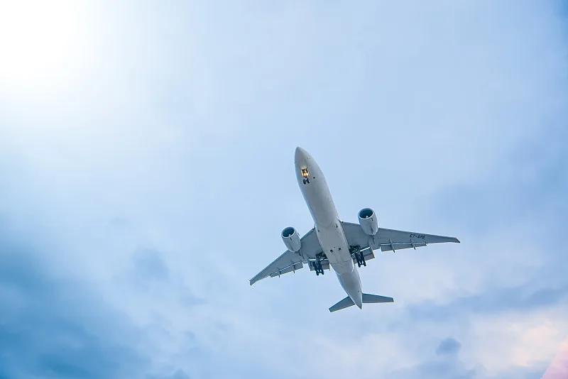 Low-angle view of a cargo plane climbing right after takeoff