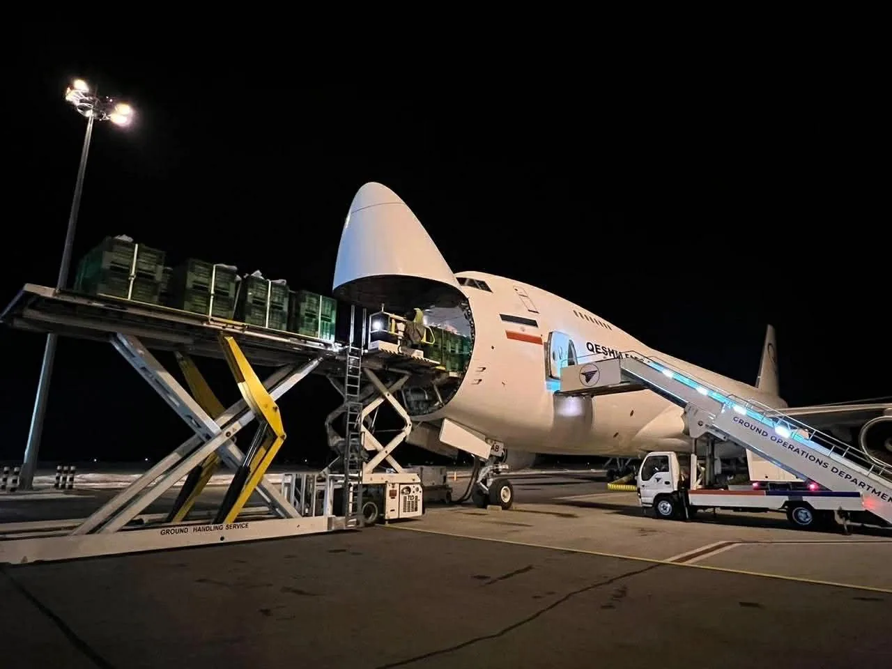 Freighter being loaded on the apron at night to meet next-flight-out schedules